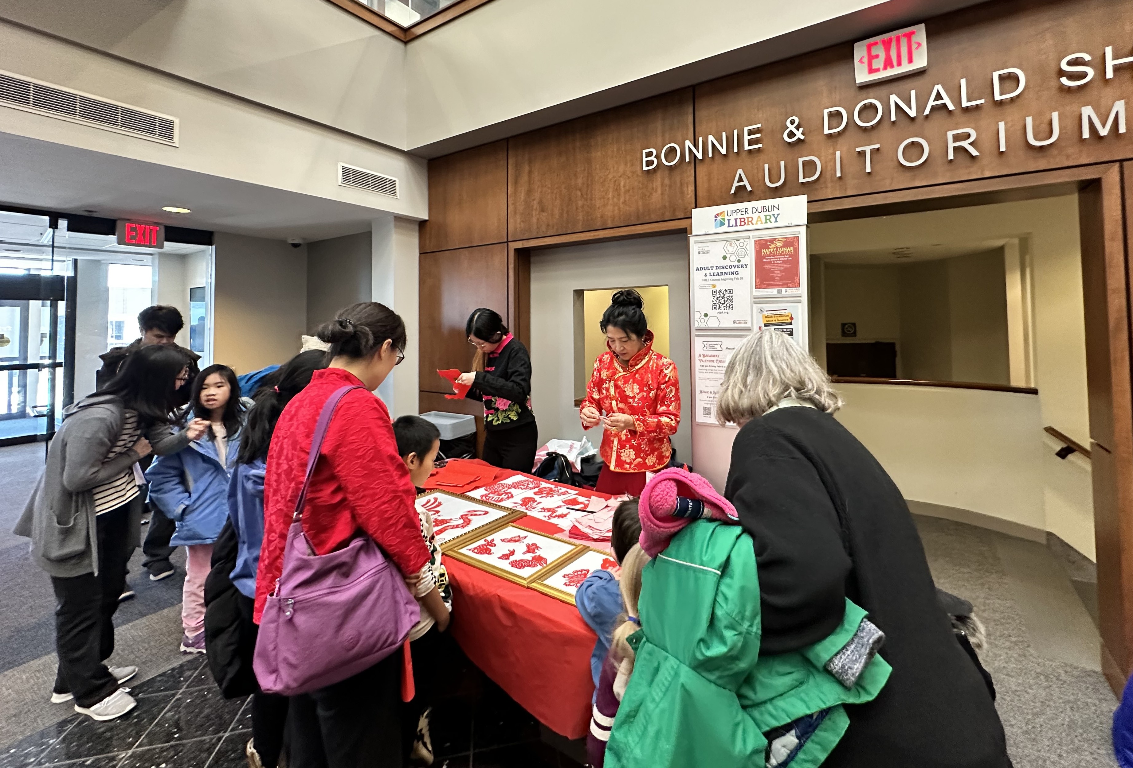 Attendees interacting with the paper cutting station.